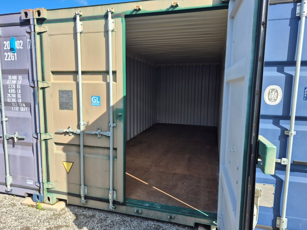 View inside an open, empty storage container showing clean wooden flooring and spacious interior ready for loading